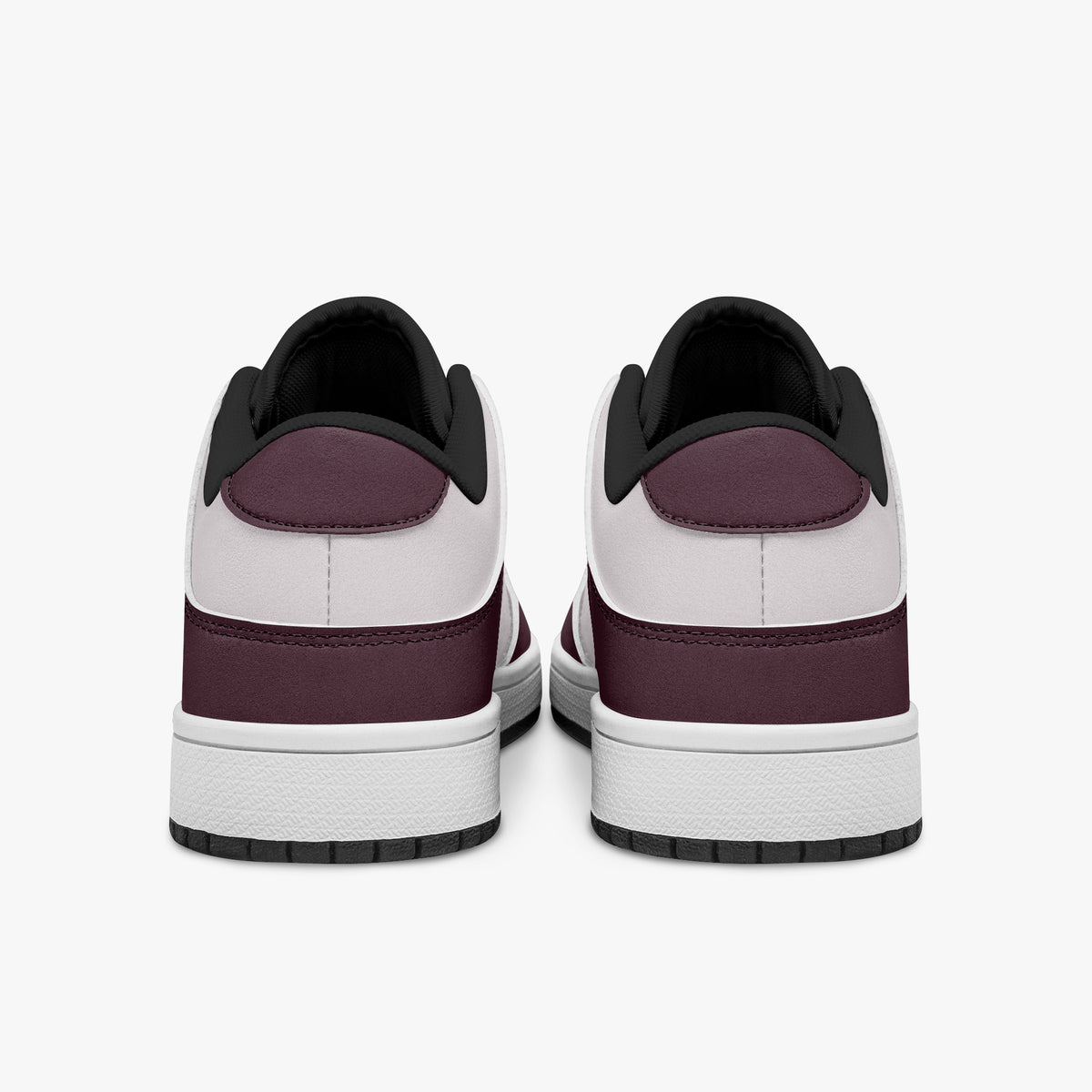 Rear view of burgundy and pale pink sneakers showing dark burgundy heel overlays, pale pink collar panels, and black interior collars above white midsoles.