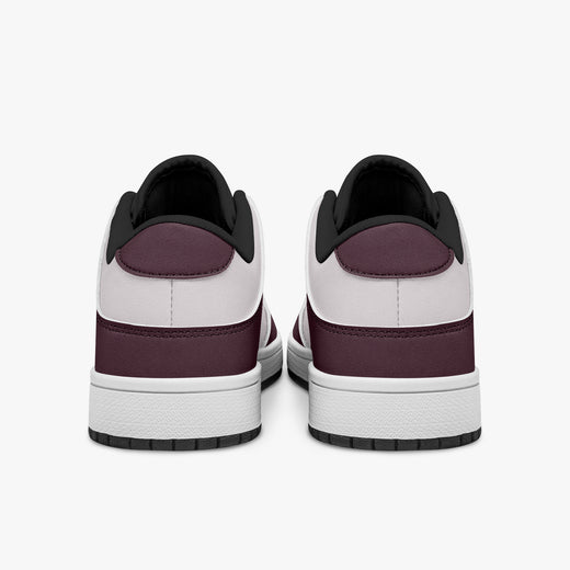 Rear view of burgundy and pale pink sneakers showing dark burgundy heel overlays, pale pink collar panels, and black interior collars above white midsoles.