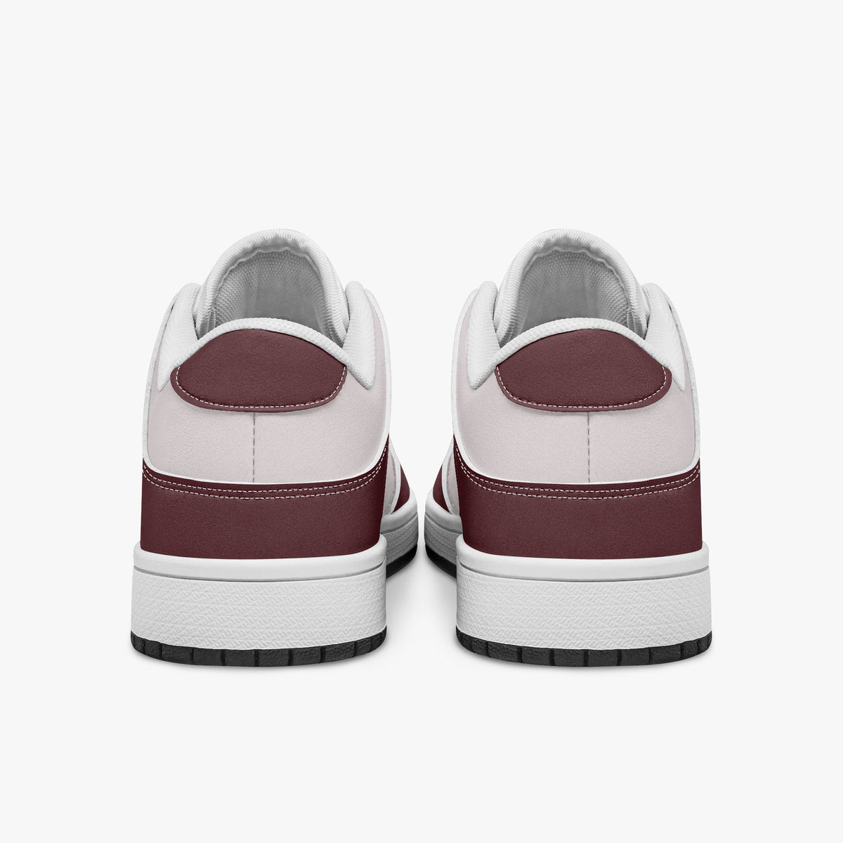 Rear view of burgundy and pale pink sneakers displaying deep burgundy heel overlays, pale pink collar panels, and two-tone white and black rubber outsoles.
