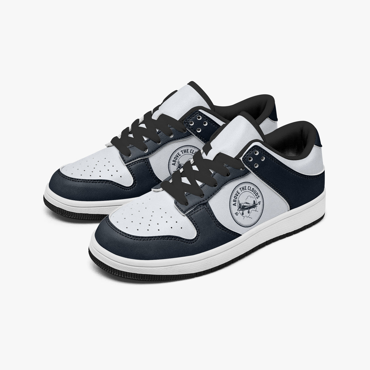 Angled three-quarter view of low-top sneakers in navy blue and off-white leather, featuring a vintage airplane graphic with "ABOVE THE CLOUDS", black laces, and a black inner lining.
