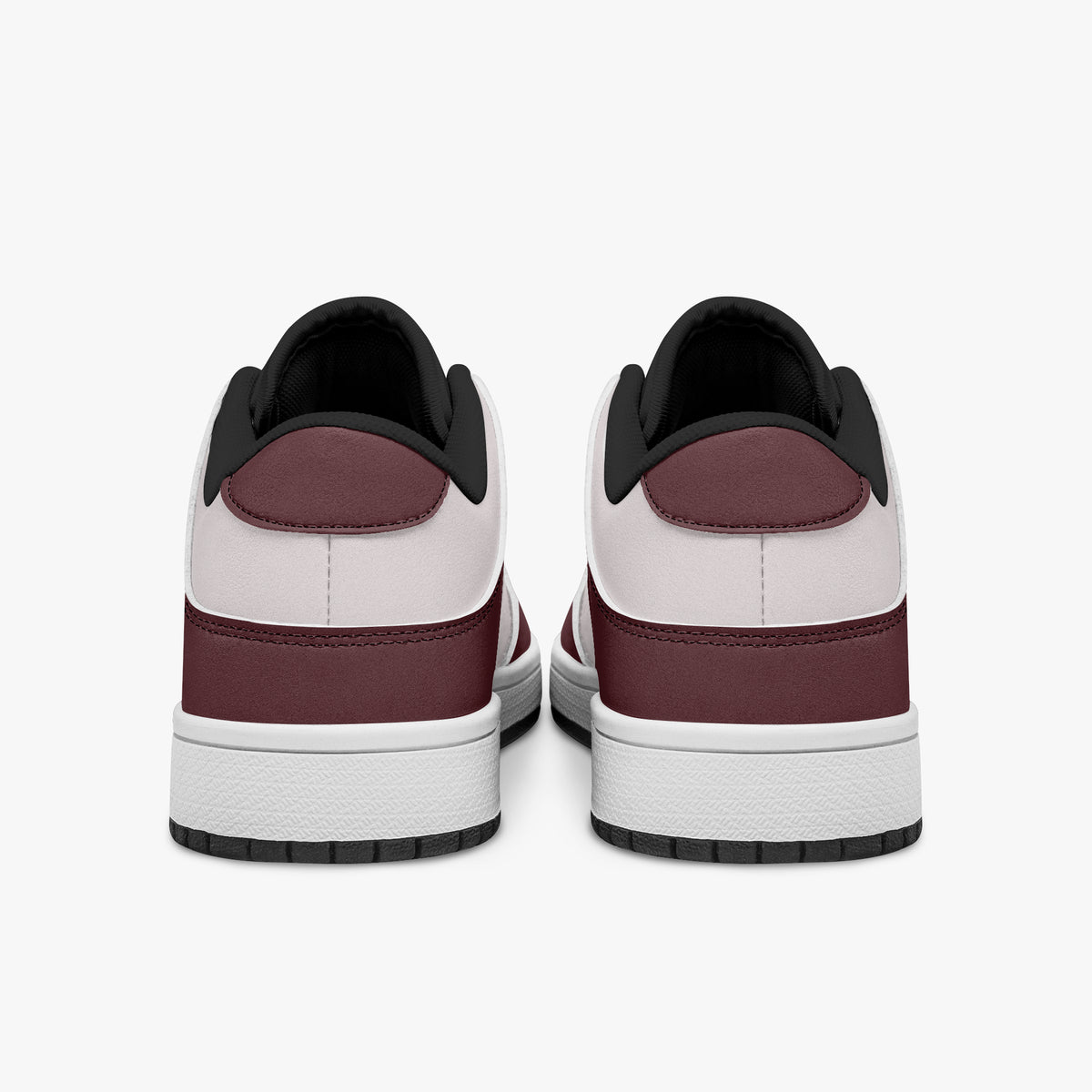 Rear view of burgundy and pale pink sneakers showing dark burgundy heel overlays, pale pink collar panels, and black interior collars above white midsoles.