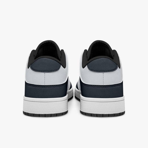 Rear view of navy blue and off-white sneakers showing dark navy heel overlays, white leather collars, and black interior collar lining above white midsoles.