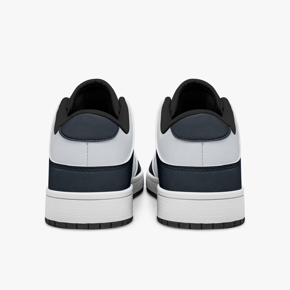Rear view of navy blue and off-white sneakers showing dark navy heel overlays, white leather collars, and black interior collar lining above white midsoles.