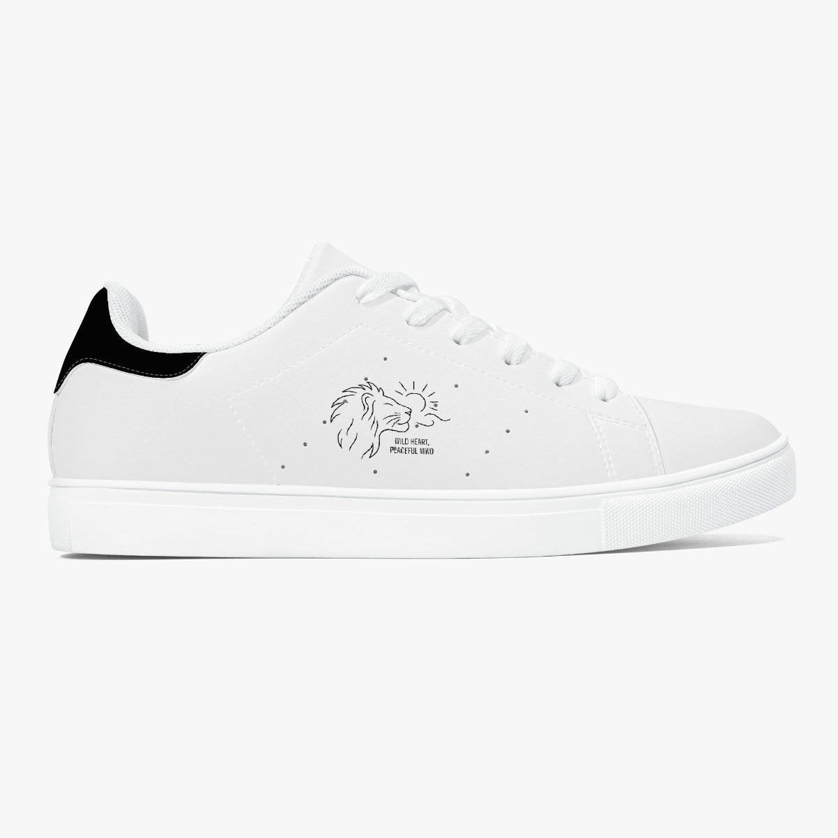 A white low-top sneaker with a black heel tab, white laces, and a black line-art lion graphic on the side with the text WILD HEART,PEACEFUL MIND