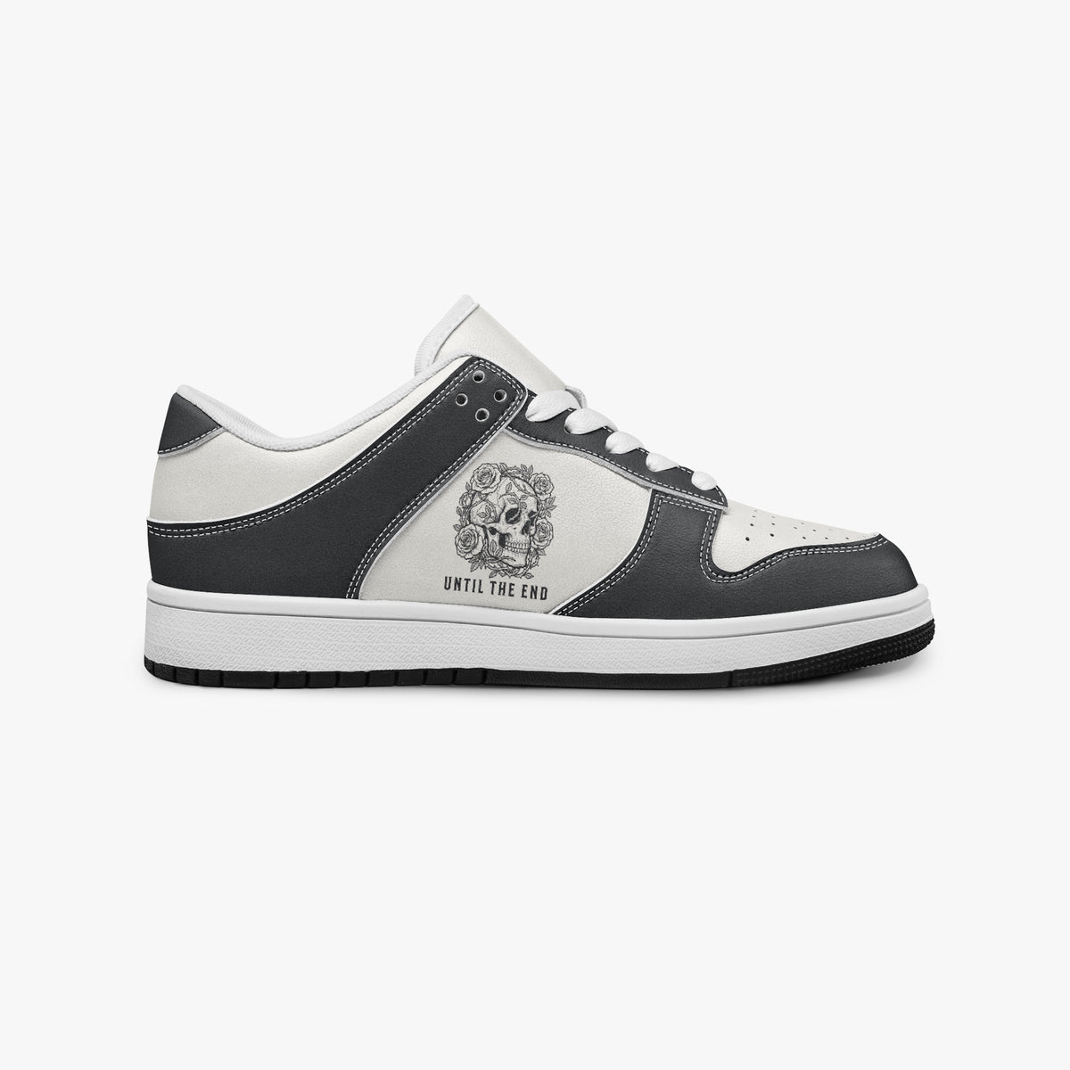 Side profile view of the right sneaker showcasing the black leather overlays, floral skull emblem, white eyelet lacing, and contrasting black outsole facing right.