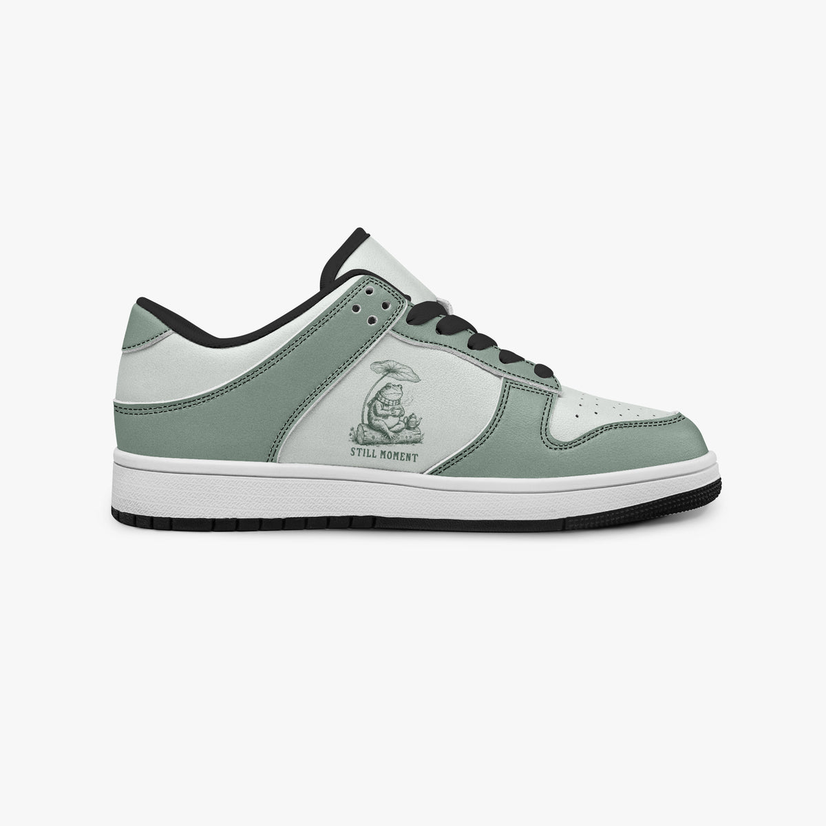 Side profile view of the right sneaker showcasing the sage green and off-white color blocking, "STILL MOMENT" design, black laces, and black rubber outsole facing right.