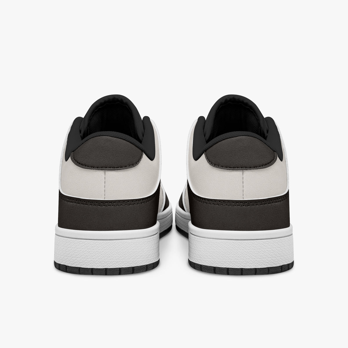 Rear view of dark brown and cream sneakers showing dark brown heel overlays, off-white leather collars, and black interior collar lining above white midsoles.