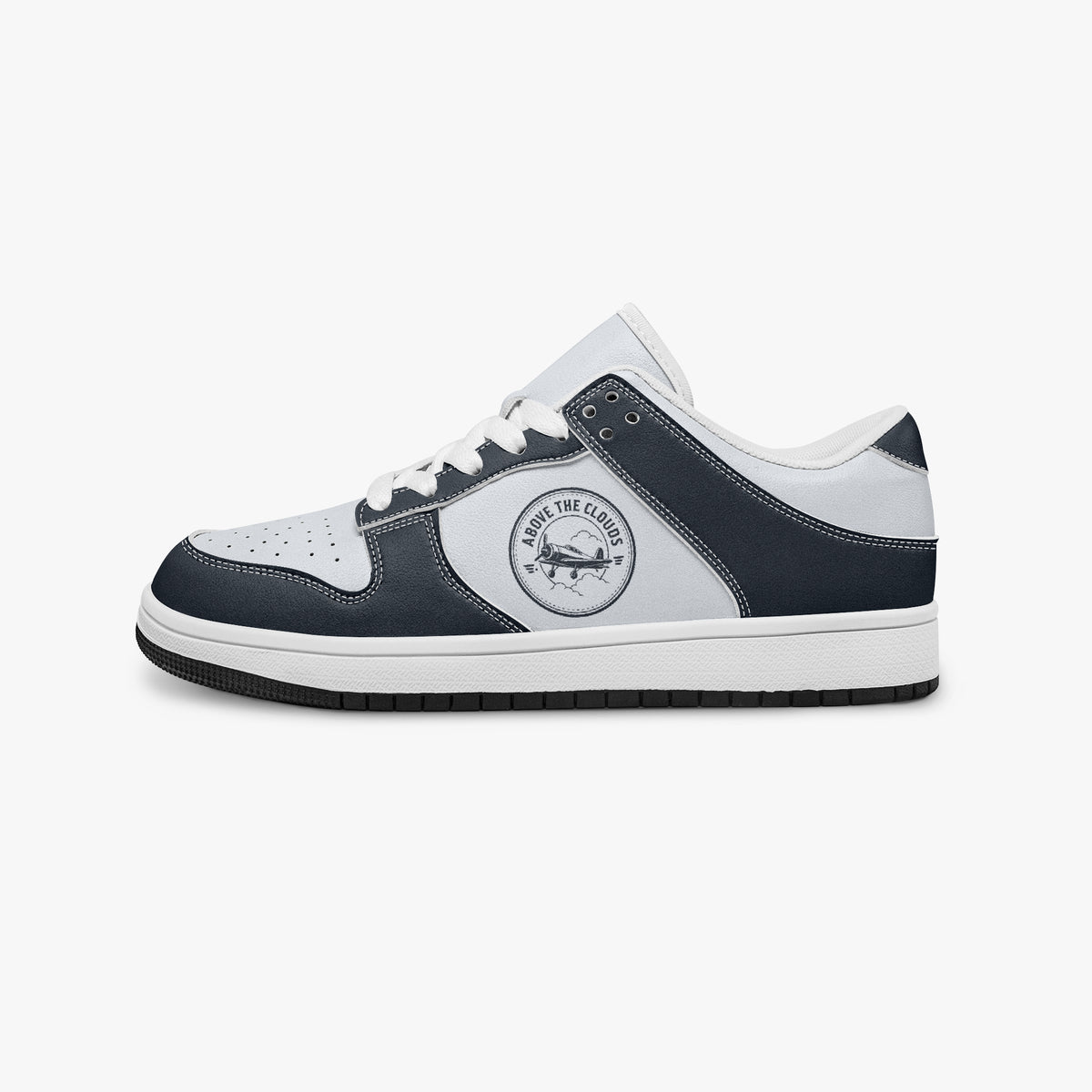 Side profile view of the left sneaker showcasing the navy leather overlays, vintage aviation graphic, white laces, white interior lining, and contrasting black outsole facing right.