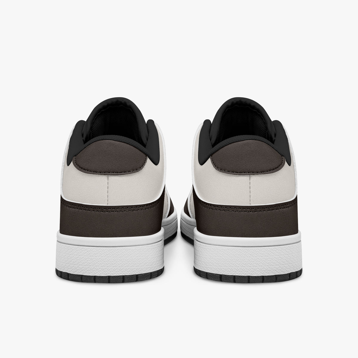 Rear view of brown and cream sneakers showing dark brown heel overlays, off-white leather collars, and black interior collar lining above white midsoles.