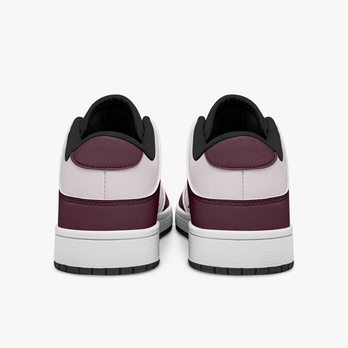 Rear view of burgundy and pale pink sneakers showing dark burgundy heel overlays, pale pink collar panels, and black interior collars above white midsoles.