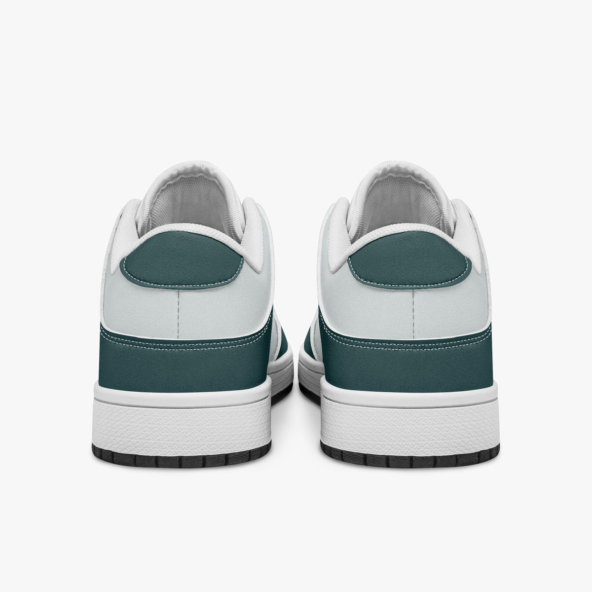 Rear view of the sneakers displaying deep teal heel overlays, white leather collar trim, and two-tone white and black rubber outsoles.