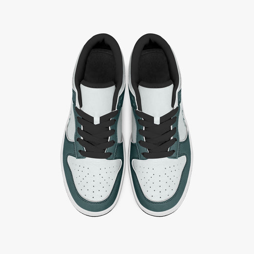 Overhead view of dark teal and white sneakers showing the black laces, perforated toe boxes, padded collars, and white leather uppers.