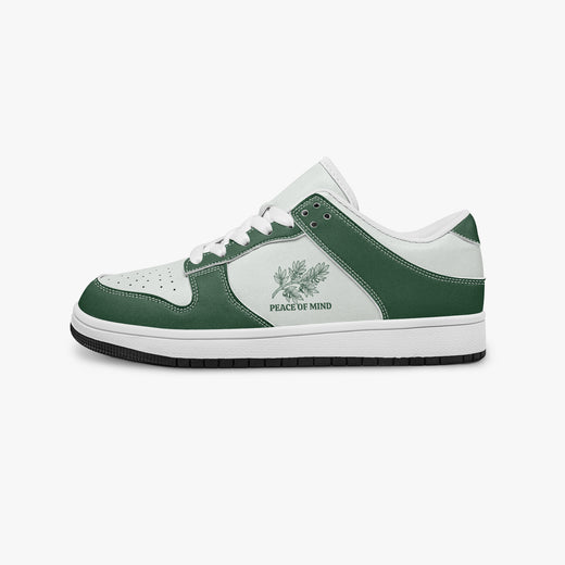 Side profile view of the left sneaker in forest green and white leather, highlighting the "PEACE OF MIND" botanical design, white laces, white interior lining, and flat rubber sole facing right.