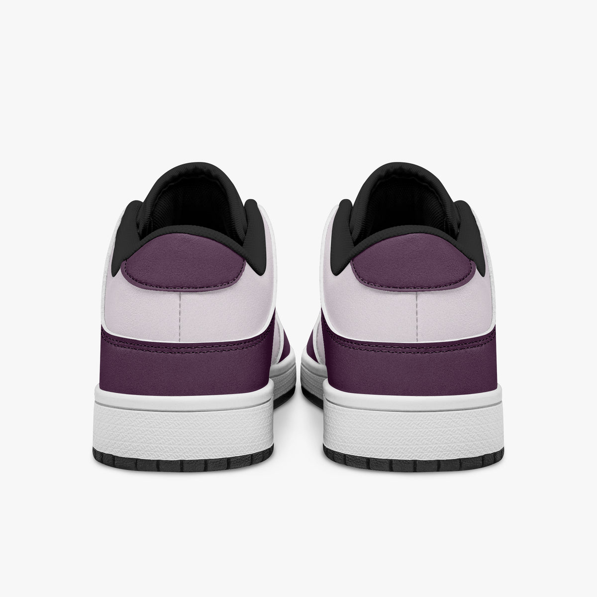 Rear view of plum and lilac sneakers displaying purple heel overlays, pale lilac collar panels, and two-tone white and black rubber outsoles.
