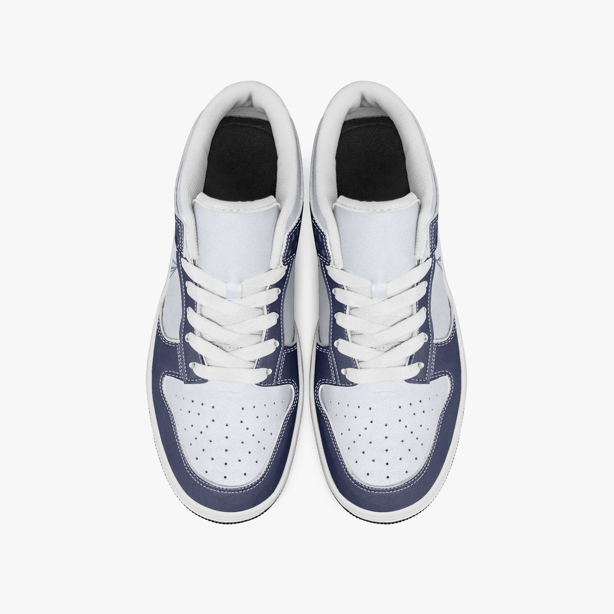 Overhead view of navy blue and white sneakers showing clean white laces, white padded collar lining, and perforated white leather toe boxes.