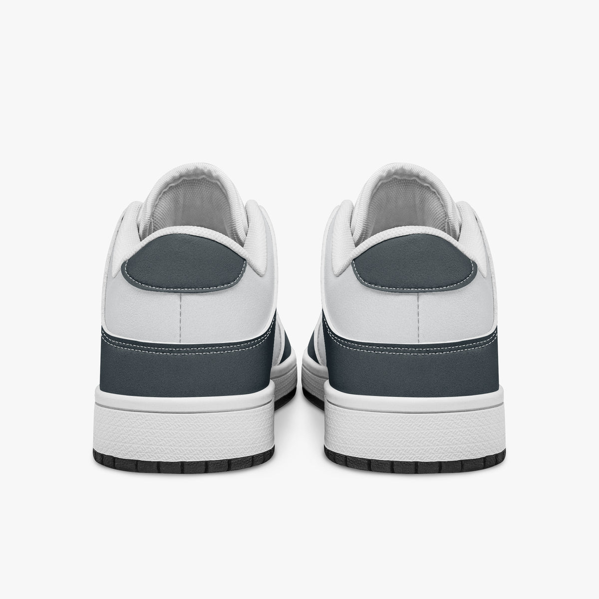 Rear view of slate blue-grey and white sneakers displaying blue-grey heel overlays, white leather collar panels, and two-tone white and black rubber outsoles.