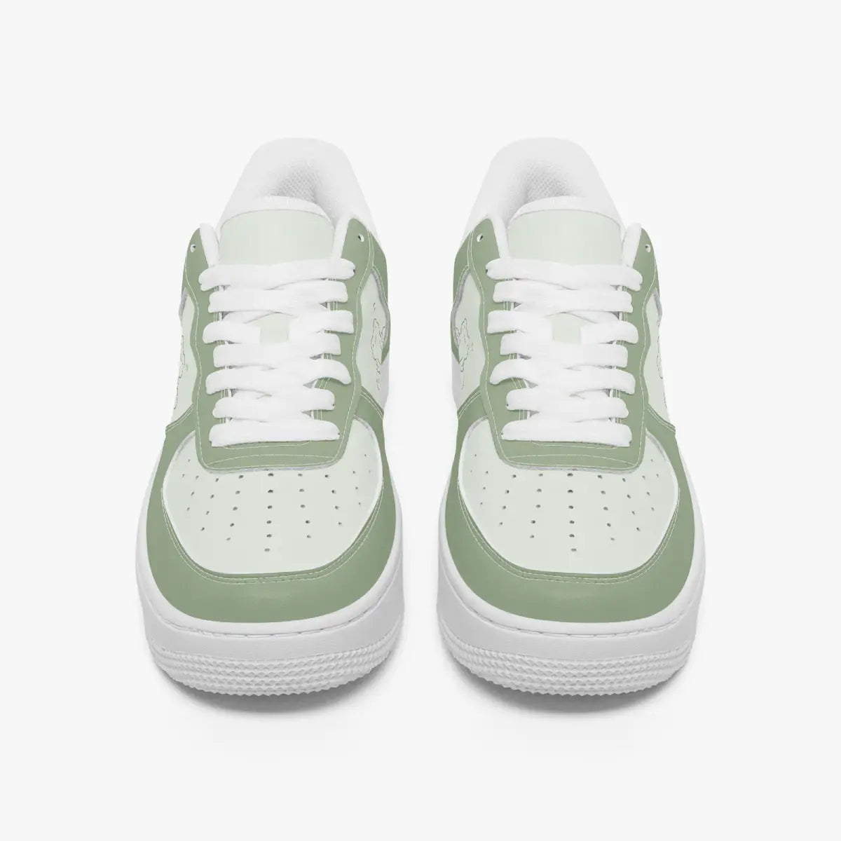 Front-facing top angle of low-top sneakers in sage green and light mint leather, displaying clean white laces, sage green eyestays, and perforated mint green toe boxes.