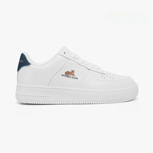 A white low-top sneaker with a navy blue heel tab, featuring a small embroidered tiger graphic and the text 'INVINCIBLE SCARS' on the side, set against a plain white background.