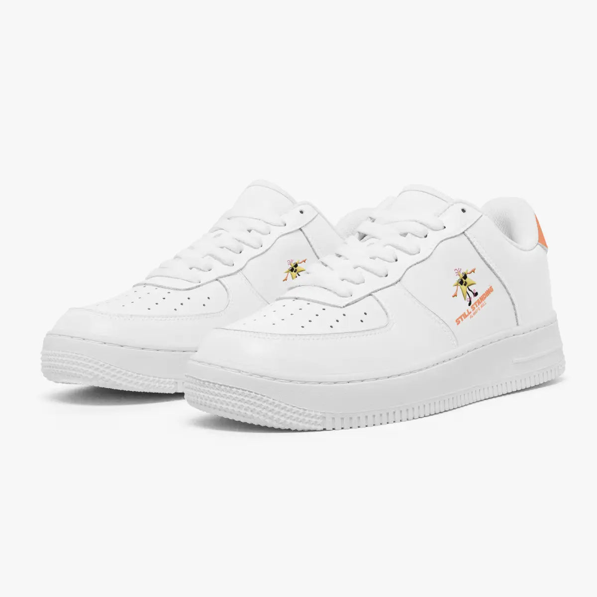 Angled three-quarter view of white leather sneakers featuring a dancing star cartoon with "STILL STANDING ALWAYS WILL" and coral orange heel tabs.