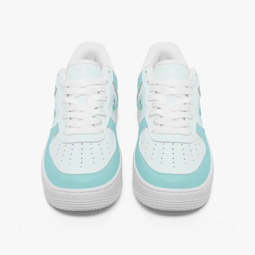 Front view of a pair of white and mint green low-top sneakers with white laces and perforated toe caps on a plain background.