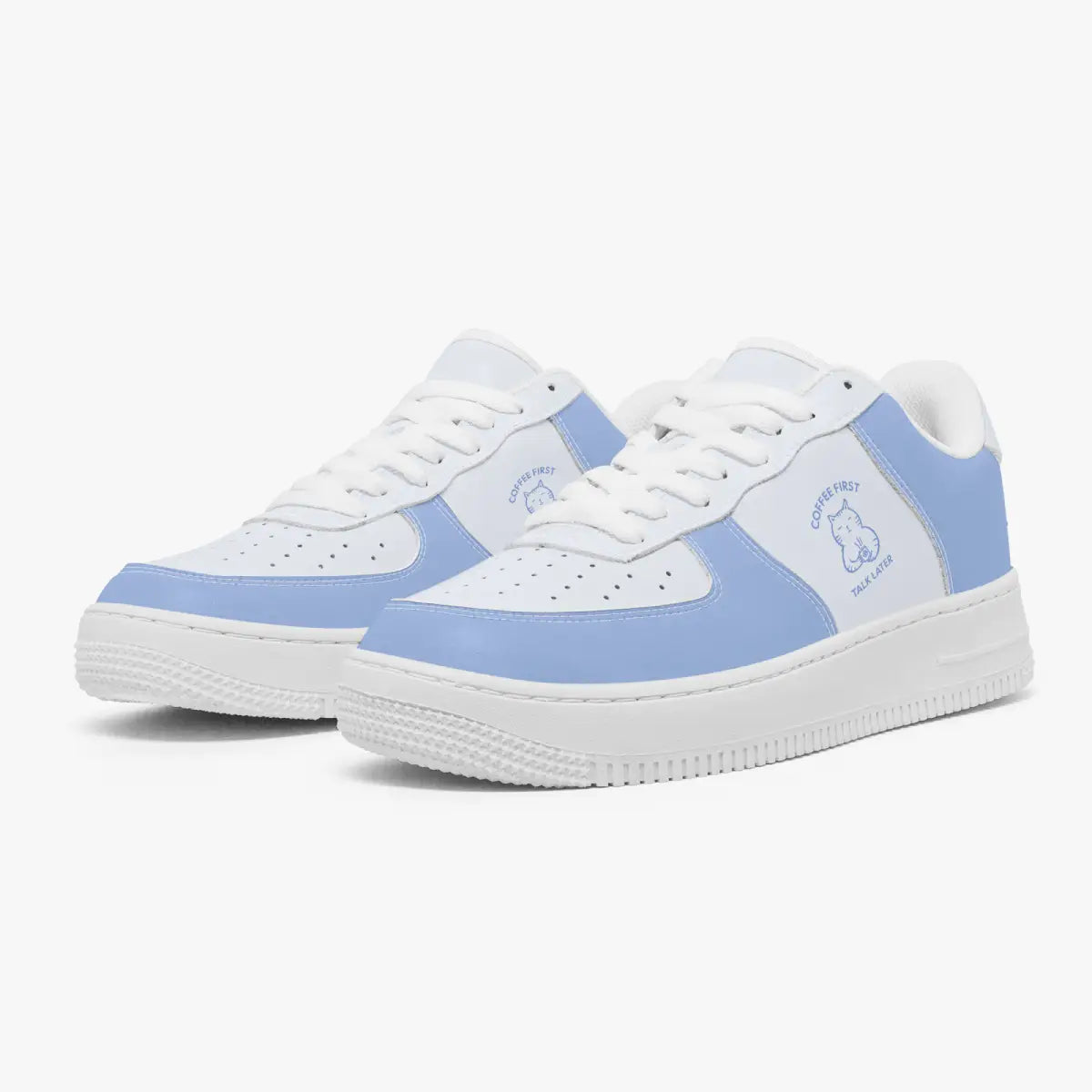 Angled three-quarter view of white and periwinkle blue sneakers featuring a minimalist line-art cat drinking coffee with "Coffee First, Talk Later" text.