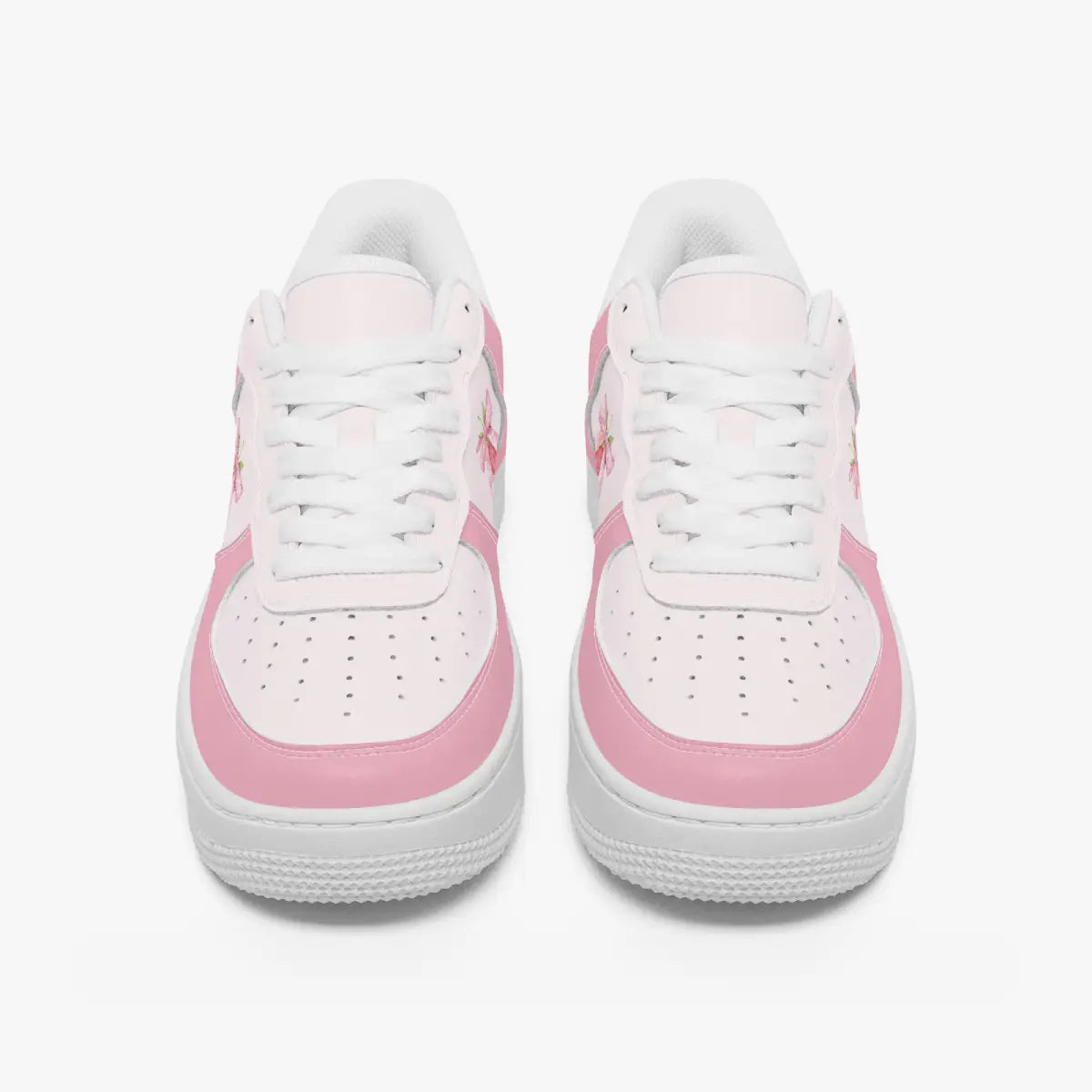 Front view of a pair of pastel pink and soft white low-top sneakers with white laces and perforated toe caps on a clean white background.