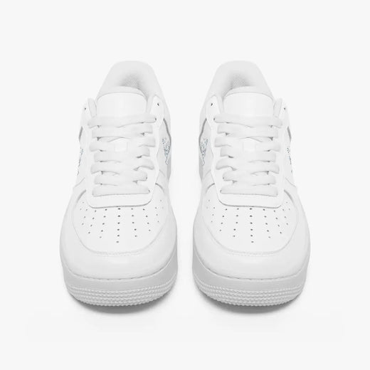 Front view of a pair of minimalist all-white low-top leather sneakers with white laces and perforated toe caps on a clean white background.