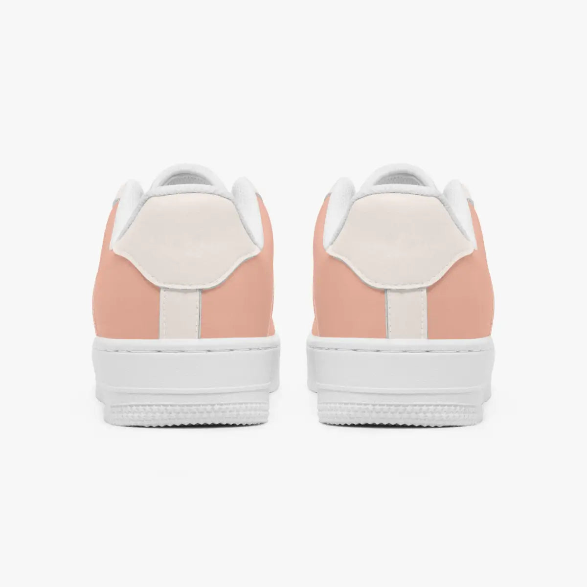 Rear view of a pair of dusty rose and cream low-top sneakers showing the padded heel counters and flat white rubber soles.