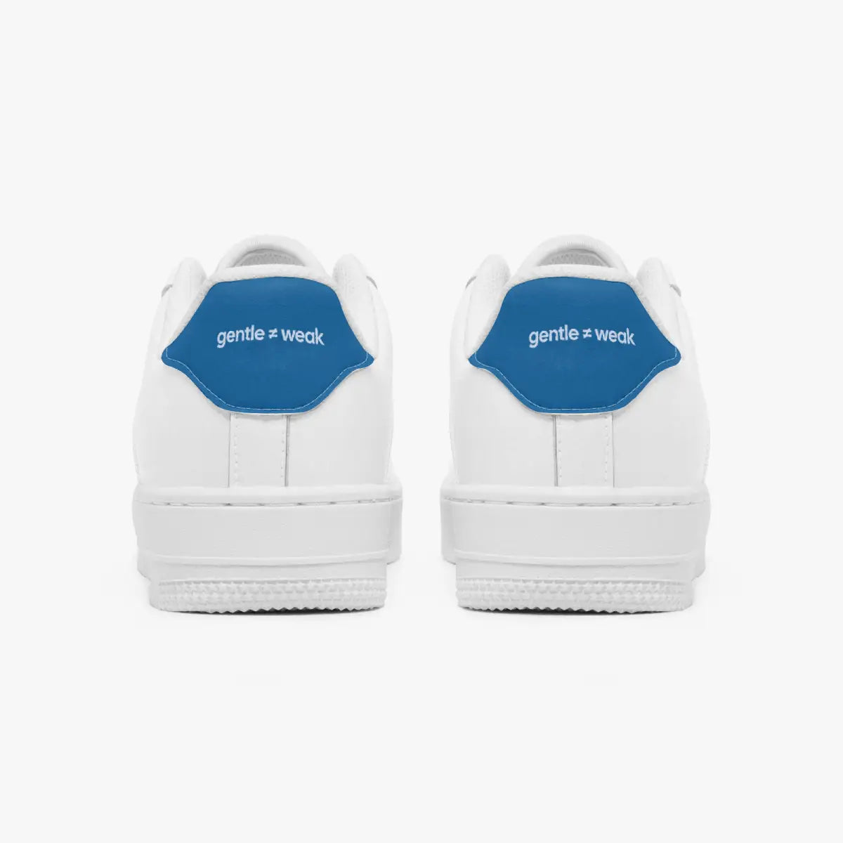 A pair of white low-top sneakers shown from the back, featuring a prominent blue heel tab with the white text 'gentle = weak'.