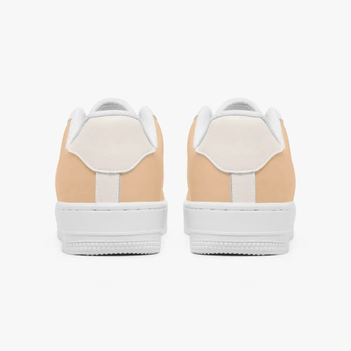 A pair of low-top sneakers shown from the back, featuring a light peach-beige suede upper with white leather heel tabs and thick white rubber soles, set against a plain white background.