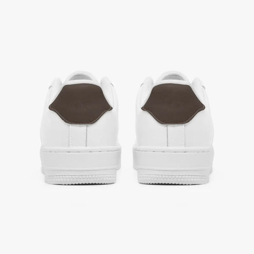 Rear view of white sneakers showing dark charcoal grey heel tabs above solid white rubber soles.