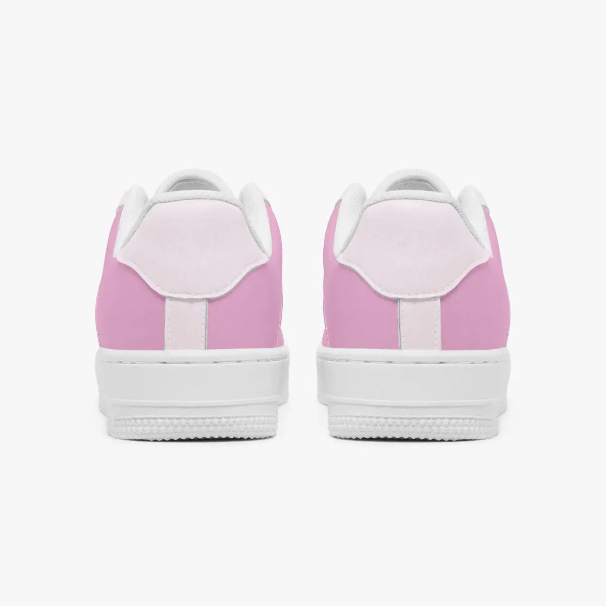 A pair of low-top sneakers shown from the back, featuring light pink panels on the sides and heel, a white leather tongue, and a thick white rubber sole.