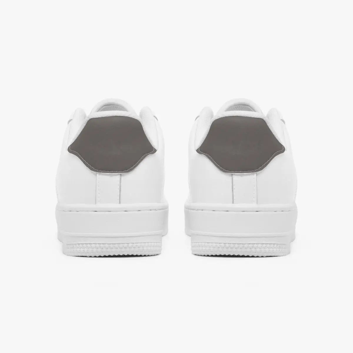 A pair of white low-top sneakers shown from the back, featuring a contrasting dark gray heel tab, set against a clean white background.