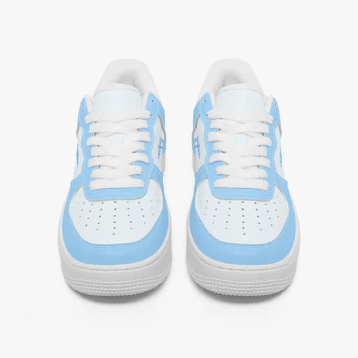 Front-facing top angle of low-top sneakers in sky blue and white leather, displaying clean white laces, sky blue eyestays, and perforated white toe boxes.