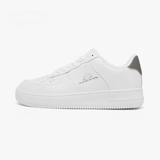A white low-top sneaker with a gray heel accent and a small graphic print on the side, shown in profile against a plain white background.