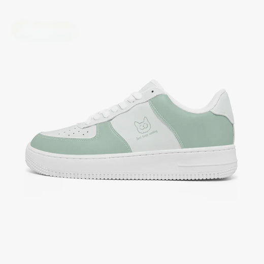 A low-top sneaker in mint green and white, featuring a white rubber sole, white laces, and a small cat face logo on the side with the text 'let's stay sunny'.