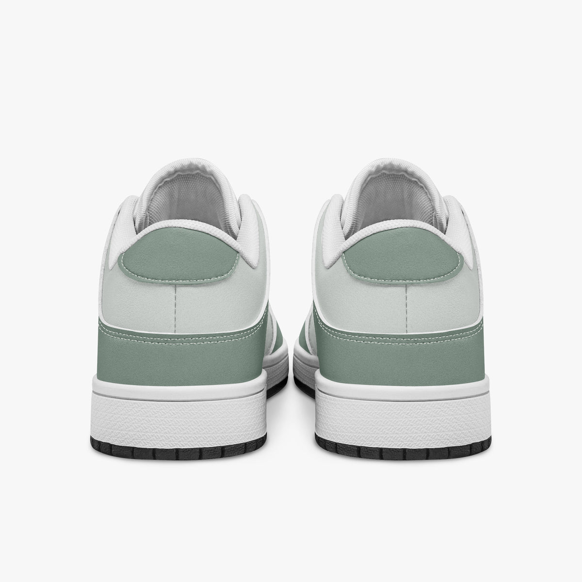 Rear view of sage green and off-white sneakers displaying sage green heel overlays, off-white collar panels, and two-tone white and black rubber outsoles.