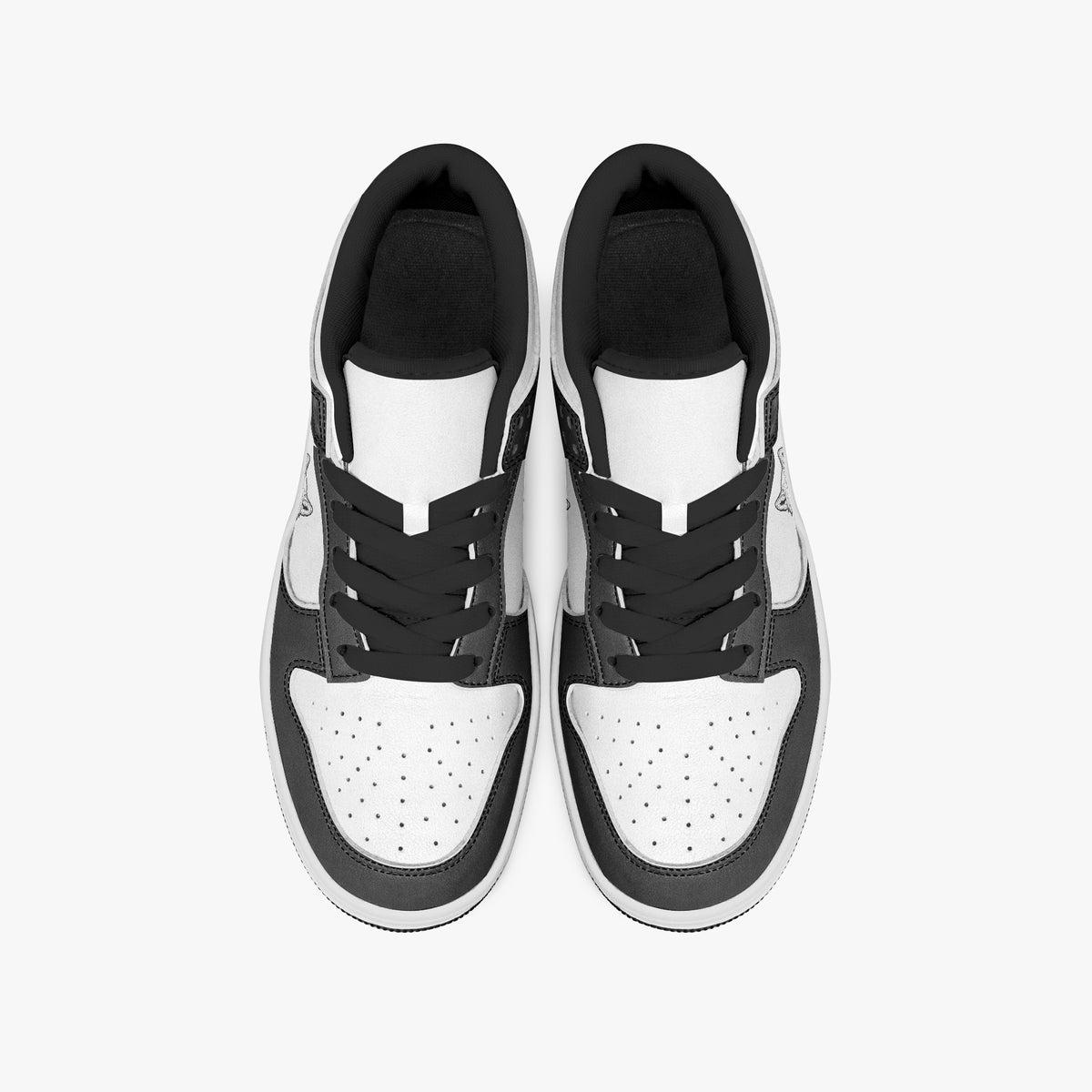Overhead view of black and white sneakers displaying black laces, black padded collar lining, and perforated white leather toe boxes.