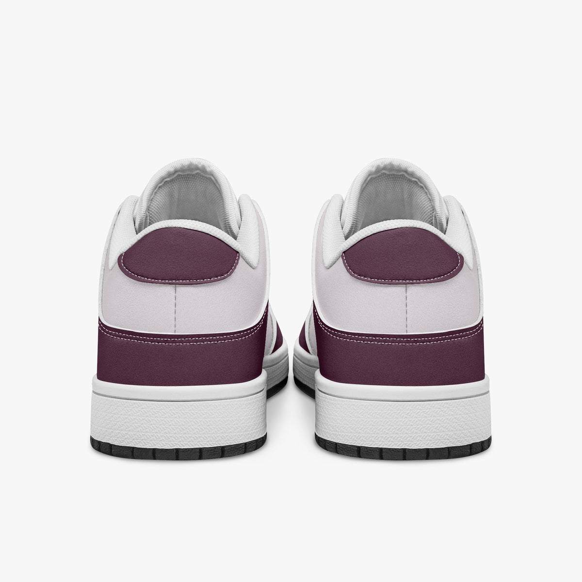 Rear view of burgundy and pale pink sneakers displaying deep burgundy heel overlays, pale pink collar panels, and two-tone white and black rubber outsoles.