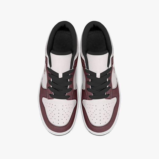 Overhead view of burgundy and pale pink sneakers displaying black laces, black padded collar lining, and perforated pale pink leather toe boxes.