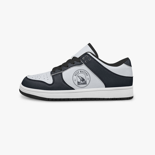 Side profile view of the left sneaker highlighting the navy leather panels, ocean wildlife emblem, black interior lining, and flat rubber sole facing right.