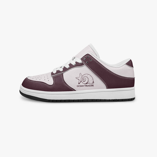 Side profile view of the left sneaker in burgundy and pale pink leather, highlighting the "OCEAN TREASURE" seashell design, white laces, white interior lining, and flat rubber sole facing right.