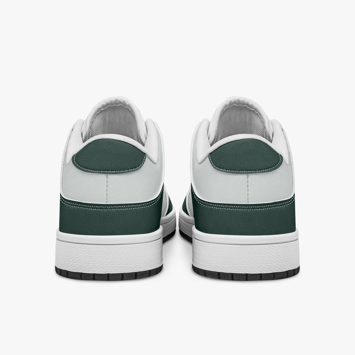 Rear view of dark green and white sneakers displaying deep green heel overlays, white leather collar panels, and two-tone white and black rubber outsoles.