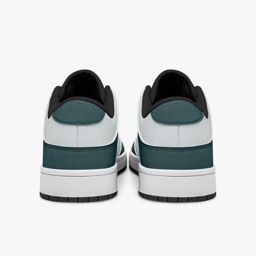 Rear view of the sneakers displaying deep teal heel overlays, white leather panels, and two-tone white and black rubber outsoles.