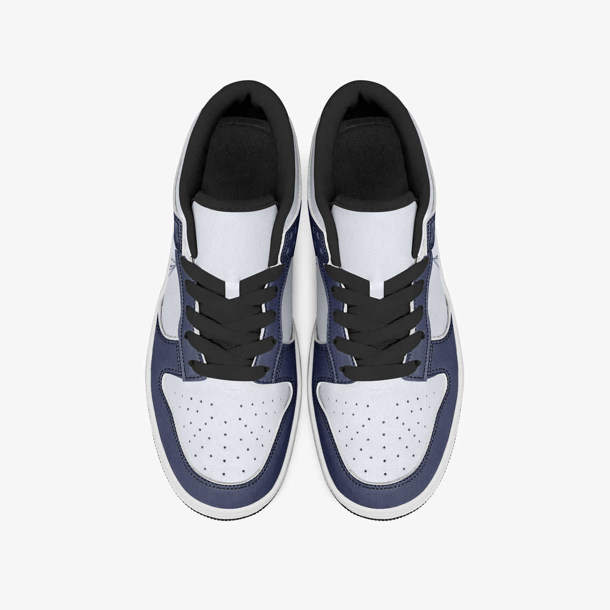 Overhead view of navy blue and white sneakers displaying black laces, black padded collar lining, and perforated white leather toe boxes.