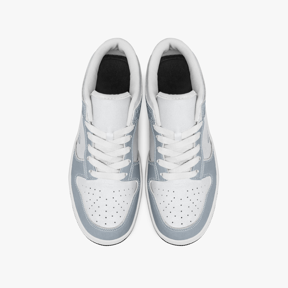 Overhead view of slate blue-grey and white sneakers showing clean white laces, white padded collar lining, and perforated white leather toe boxes.