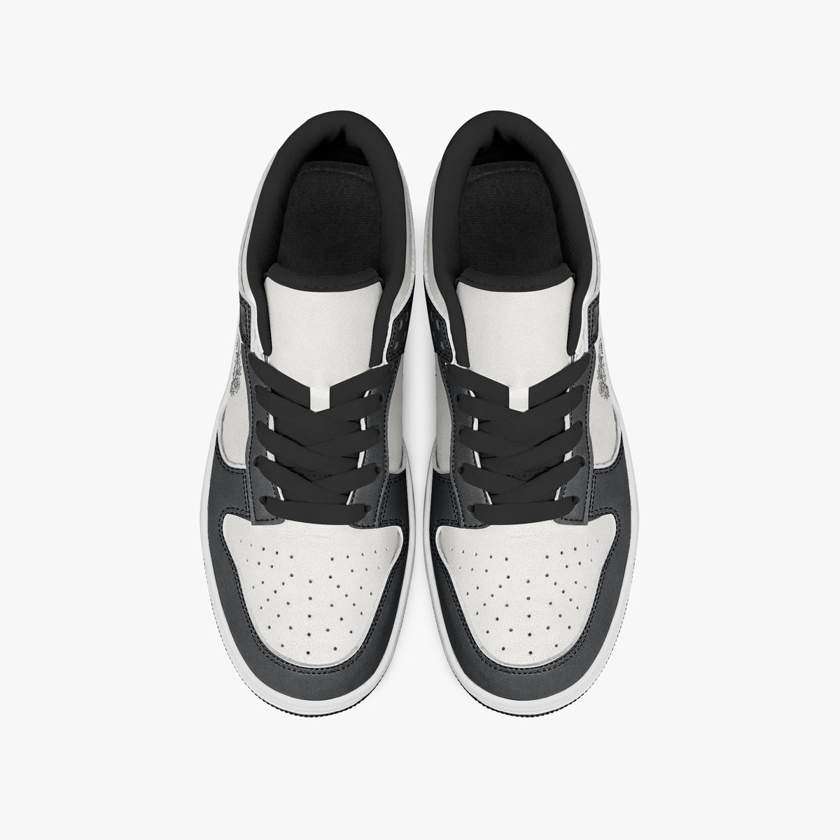 Overhead view of black and white sneakers displaying black laces, black padded collar lining, and perforated white leather toe boxes.