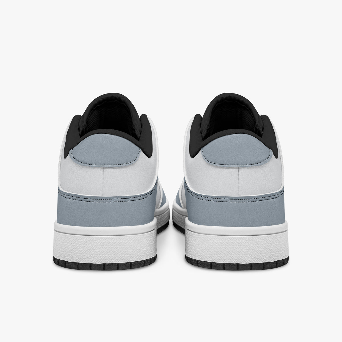 Rear view of slate blue-grey and white sneakers showing slate blue-grey heel overlays, white leather collars, and black interior collar lining above white midsoles.