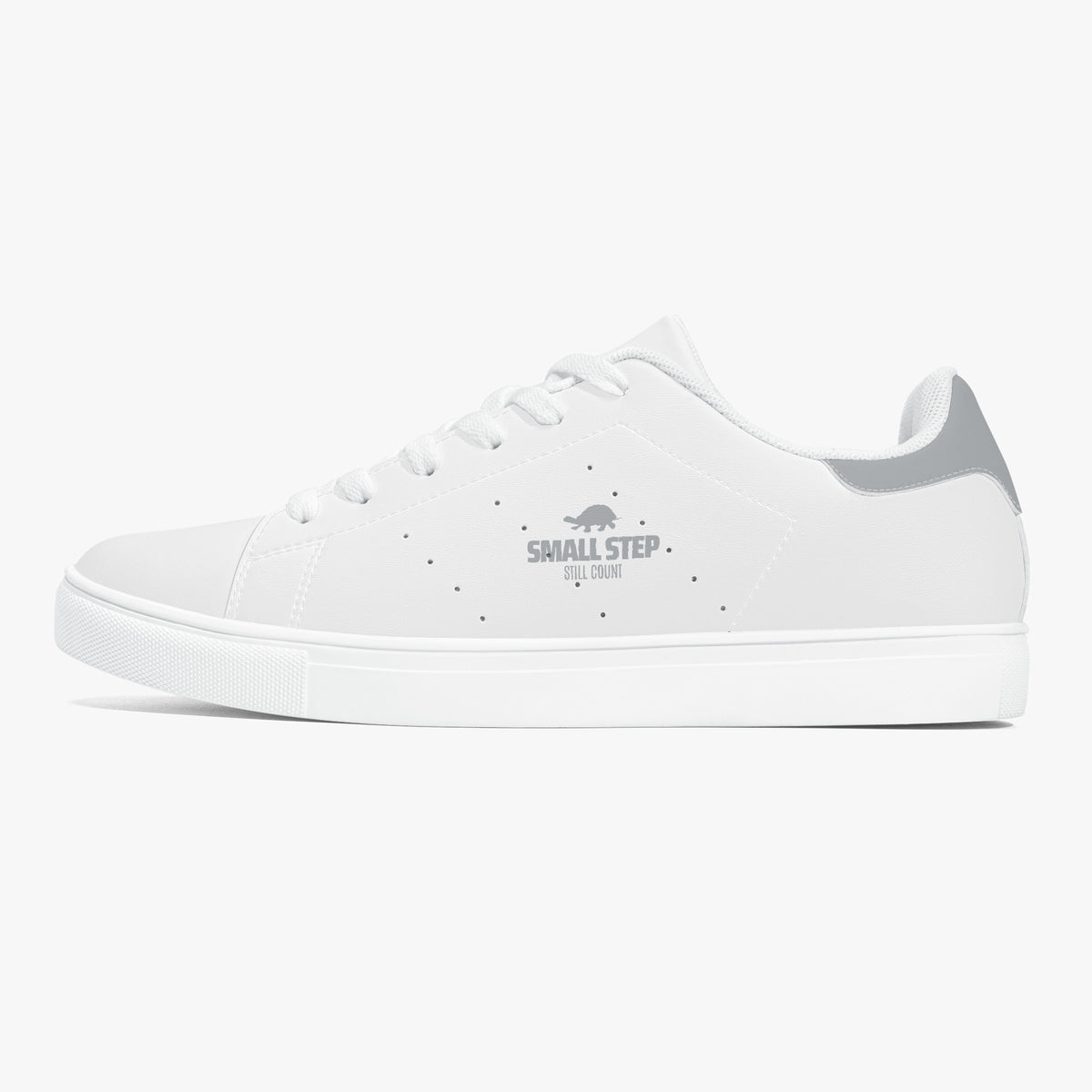 A white low-top sneaker with a gray heel accent and a gray 'SMALL STEP by CUBAN' logo printed on the side, shown against a light gray background.