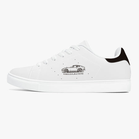Side profile view of the left sneaker in smooth white leather, showcasing the vintage car graphic, black heel tab detail, white laces, and flat white rubber cupsole facing right.
